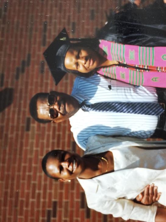 Celebrating a recent graduate outdoors with family, filled with pride and joy.