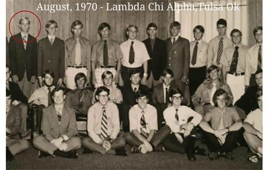 Group of young men posed together in formal attire, smiling for a group photograph in August.