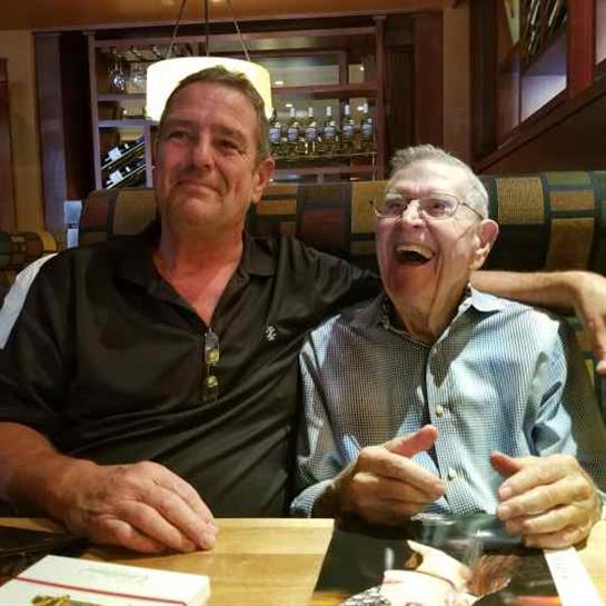 Friends share laughter and companionship while seated at a restaurant table, creating memories.