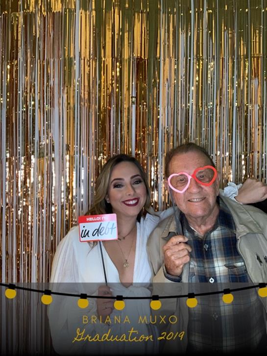 Cheerful gathering with two friends posing for a picture using playful glasses and signs.