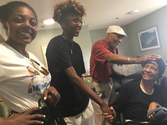 Four friends share laughter and smiles while getting haircuts in a cozy barbershop.