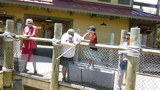 A group of family members engages in fishing activities while enjoying the warm weather.