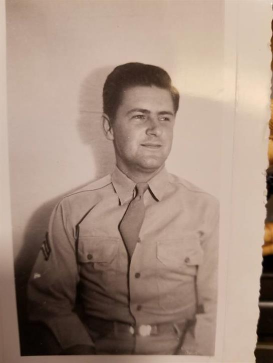 A young soldier in uniform poses confidently, capturing a historic moment.