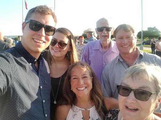 People enjoy a fun outdoor gathering, smiling under the sun in a festive atmosphere.