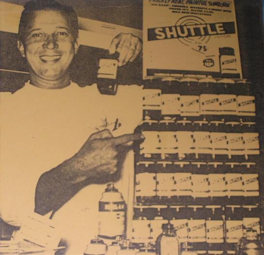 Store clerk joyfully points at product shelves, highlighting special offers in a nostalgic setting.