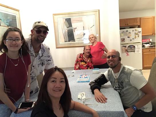 Group of friends smiling and enjoying each other's company at a lively gathering at home.