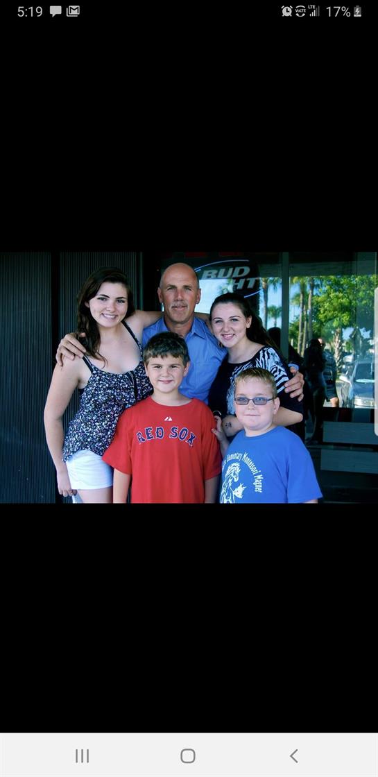 Friends and family gather for a joyful moment outside, capturing smiles and laughter together.