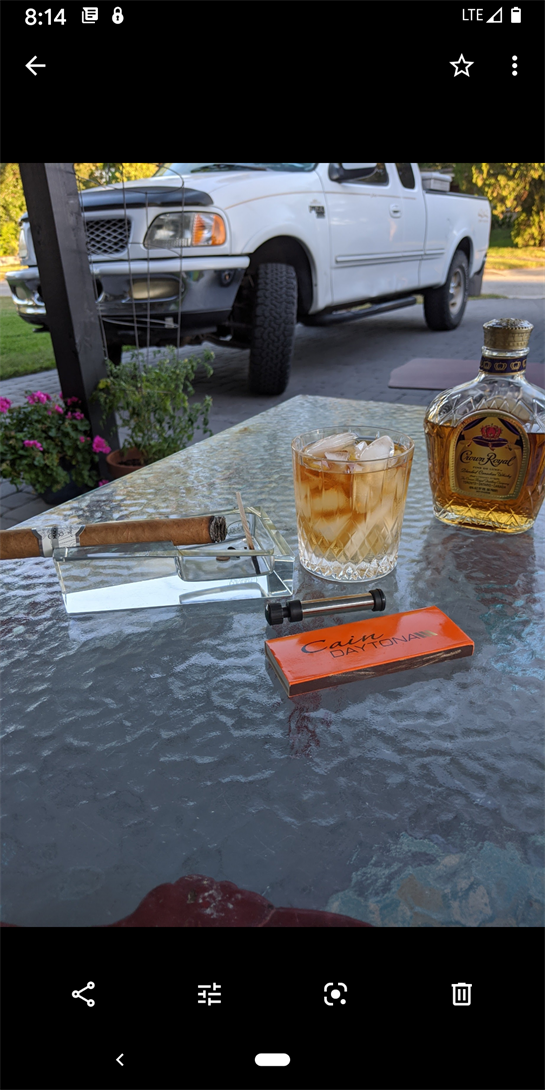 Enjoying a cigar and a drink at sunset on a patio with a nicely designed table.