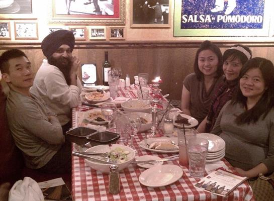 Friends share laughs and stories around a table of delicious food during dinner.
