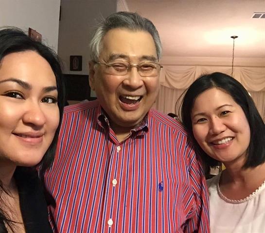 Friends and family pose together, smiling and enjoying their time at a festive indoor event.
