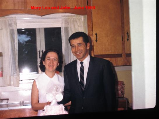 A couple stands happily together in a kitchen, capturing a memorable moment filled with joy.