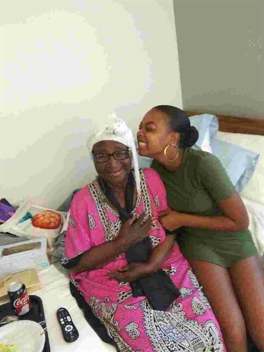 Granddaughter hugs her grandmother in a joyful visit full of laughter and memories.