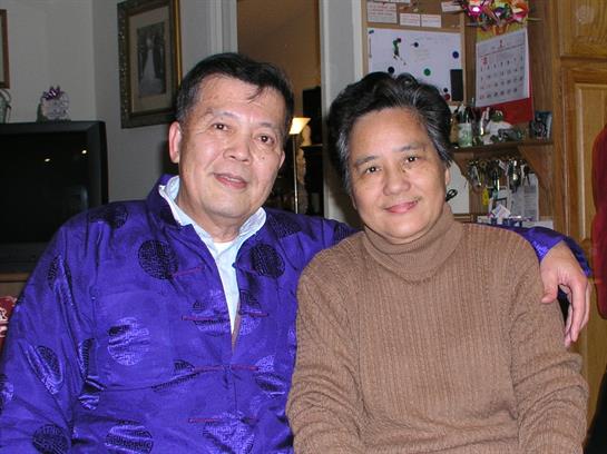 Two people smile warmly while sitting close together in their inviting living space.