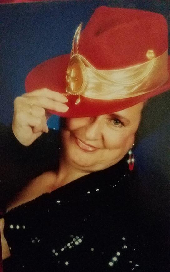A woman showcases her vibrant personality while wearing a stylish red hat, exuding confidence.