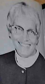A man wearing glasses smiling