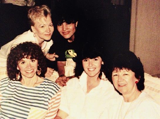 Friends share joyful moments together, smiling and enjoying each other’s company indoors.