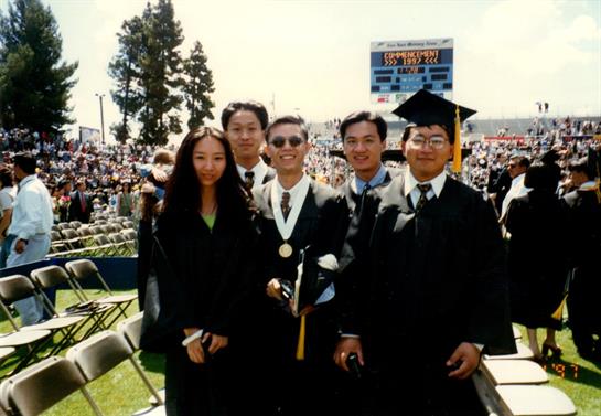 Celebration of academic achievement with friends in caps and gowns at a university graduation event.