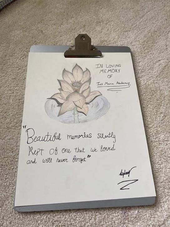 A hand-drawn sketch of a lotus flower accompanied by a loving memory quote is displayed.