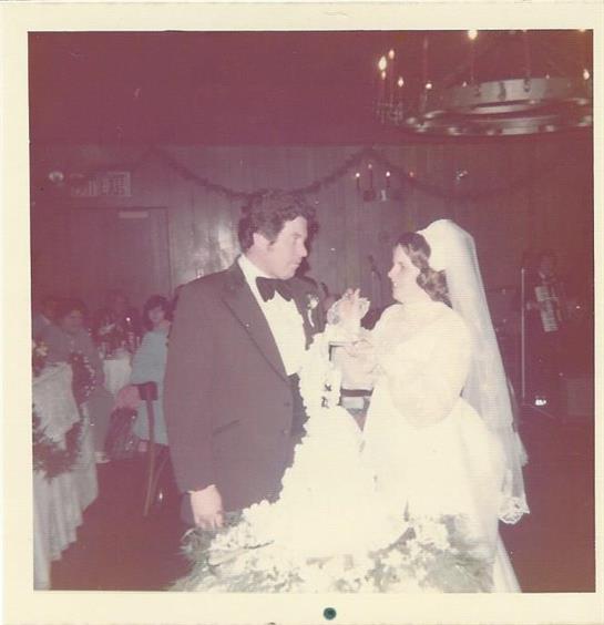 A bride and groom exchange vows and joy at their wedding reception in an upscale setting.