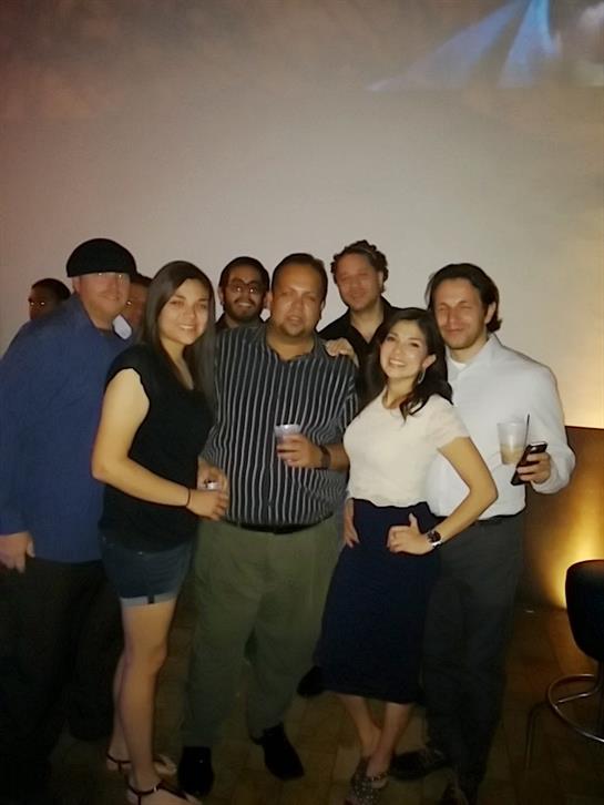 Friends gather together at a lively social event, sharing drinks and smiles in a vibrant atmosphere.