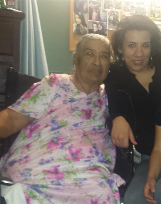 Two individuals share a warm moment together in a comfortable living space, smiling happily.