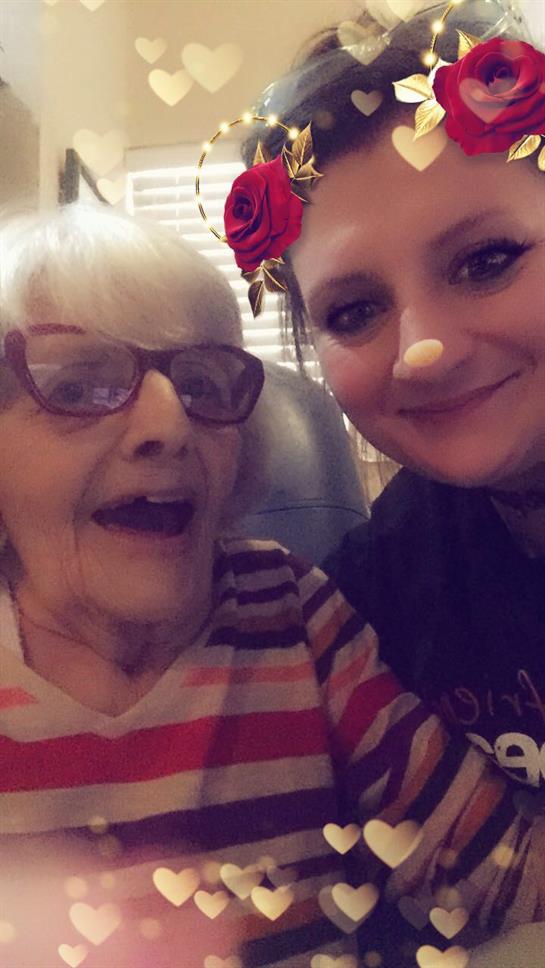 Granddaughter and grandmother share joyful moments together, showcasing love and connection.