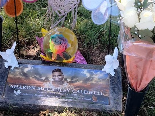 Colorful flowers and a heartfelt tribute honor Aaron McCauley Caldwell's resting place.