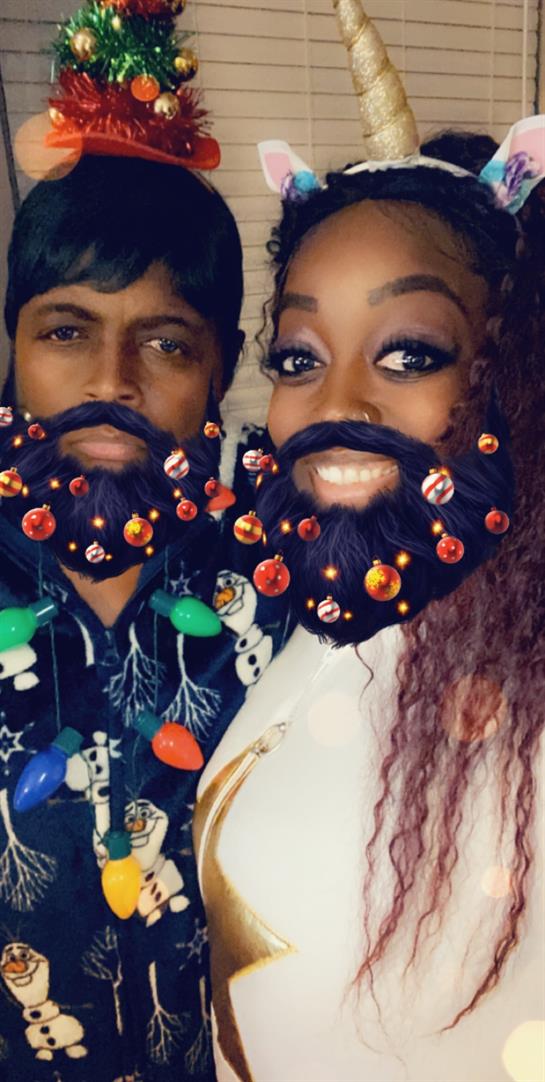 Two friends showcase creative decorated beards while enjoying a festive celebration together.