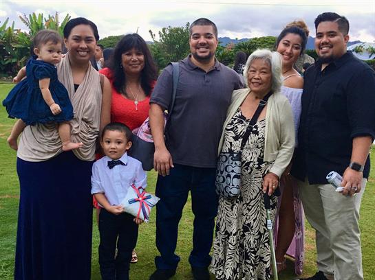 A joyful family gathering takes place in a vibrant park, showcasing smiles and connections.