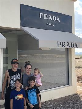 Visitors gather for a picture in front of a unique art installation in the Texas desert.