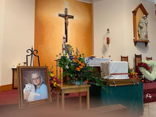 A memorial service occurs inside a church, featuring flowers and a portrait honoring a loved one.