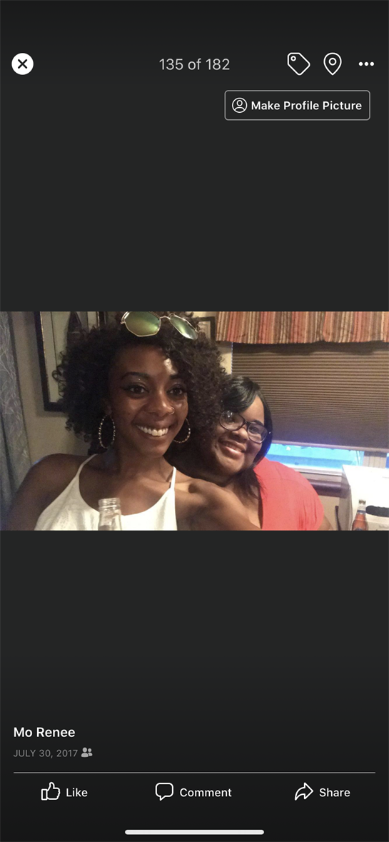 Two women smile happily while posing together, celebrating their friendship in a warm atmosphere.