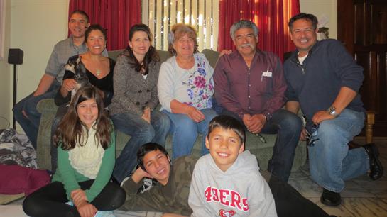 Friends and family enjoy togetherness in a warm living room filled with joy and conversation.