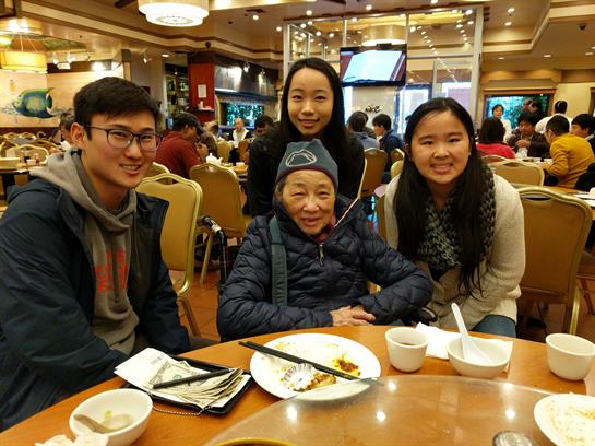 Friends and family gather around a table, enjoying a meal and each other's company in a restaurant.
