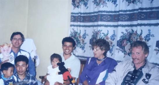 Relatives share laughter and warmth while enjoying each other's company in a cozy setting.