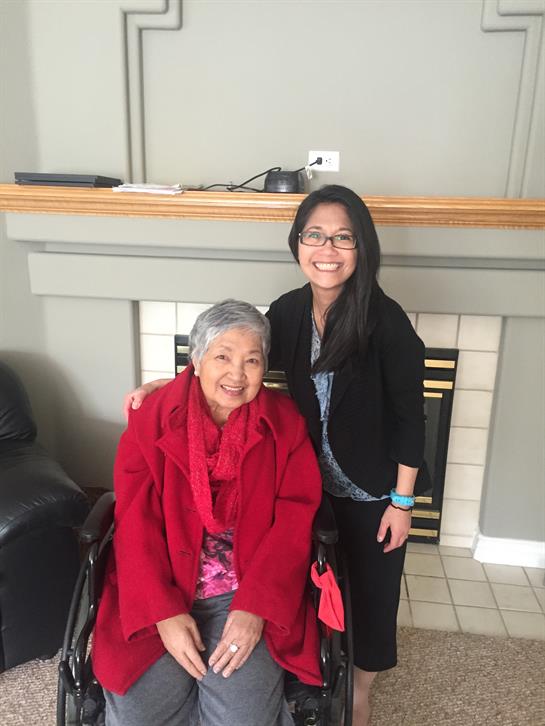 Two women share a joyful moment in a warm indoor environment, showcasing friendship and connection.