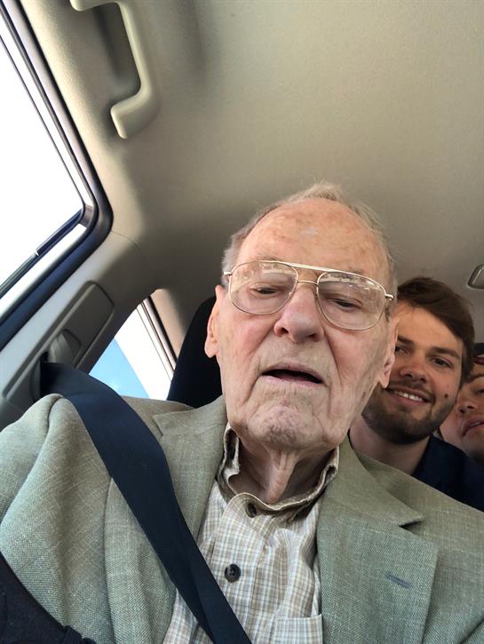 A joyful group enjoys a car ride together, highlighting connection and shared experiences.