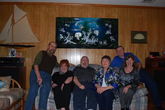Group of friends enjoying time together in a warmly decorated living room.