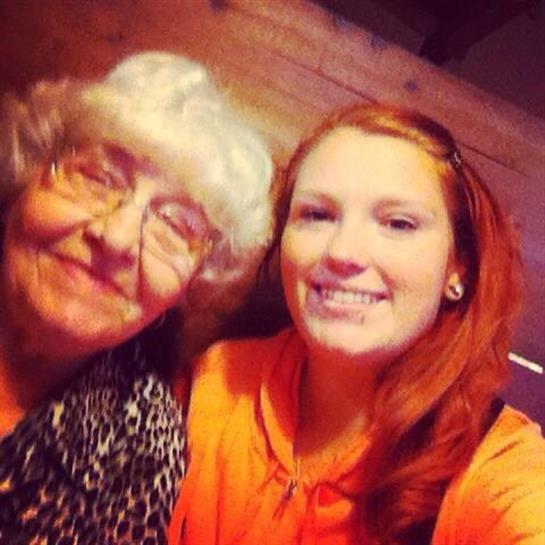 Grandmother and granddaughter enjoy quality time together, smiling warmly in a welcoming space.