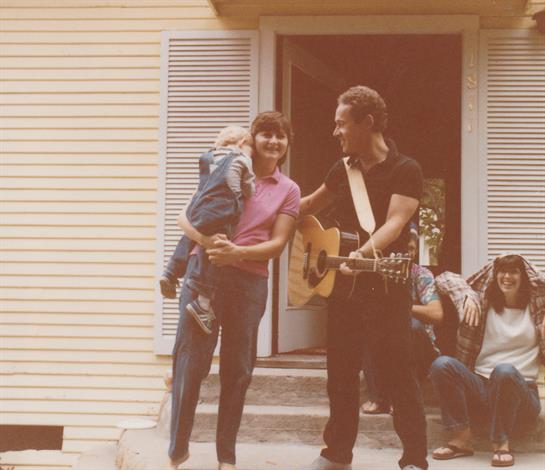 A joyful family moment takes place outdoors with music, laughter, and closeness among loved ones.