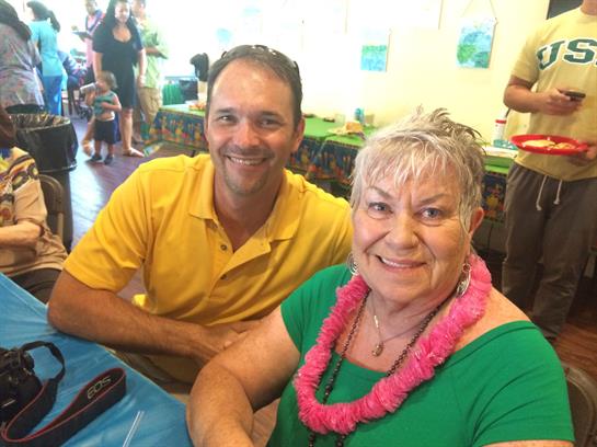 Two adults enjoy each other's company in a lively setting decorated for a celebration.