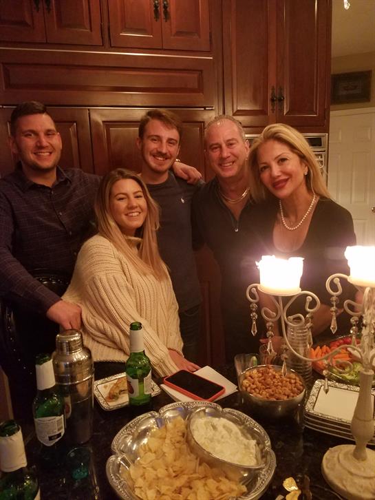 Friends gather, sharing food and drinks, enjoying a warm, inviting atmosphere together.