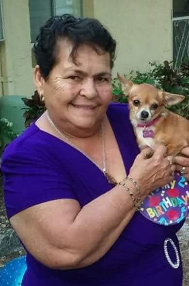 A woman holding a dog