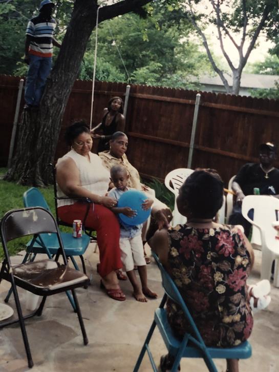 Families and friends enjoy a joyful gathering in a backyard, sharing laughter and memories.