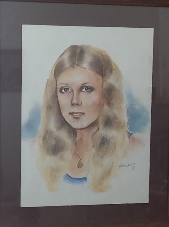 Softly drawn portrait features a young woman with flowing blonde hair and captivating blue eyes.