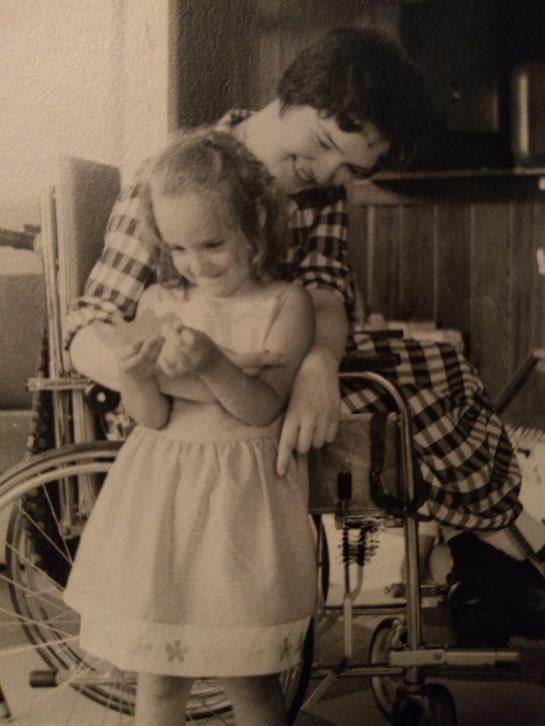 A girl shares a joyful moment with her caregiver in a vintage room during the afternoon.