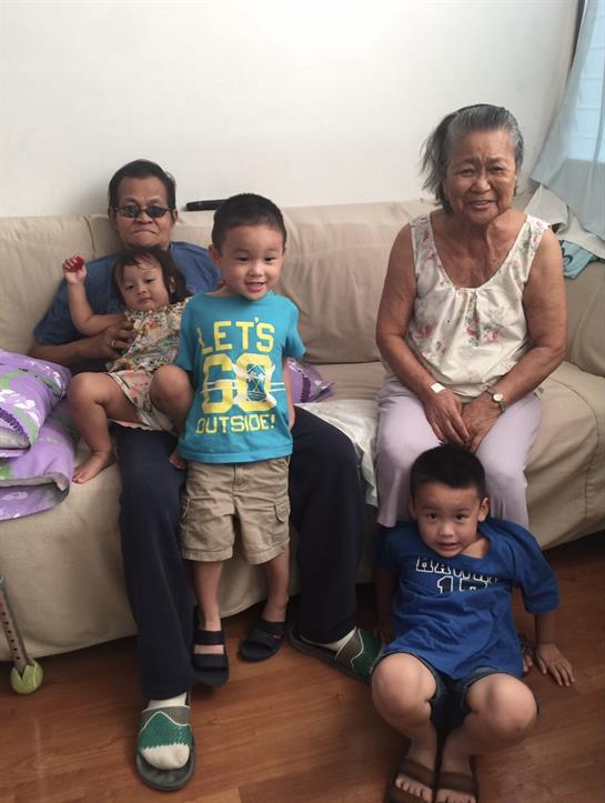 Grandparents and grandchildren share joyful moments together in a cozy home setting.