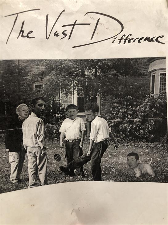 Group of four young men interacting outdoors, enjoying a lively conversation in a park setting.