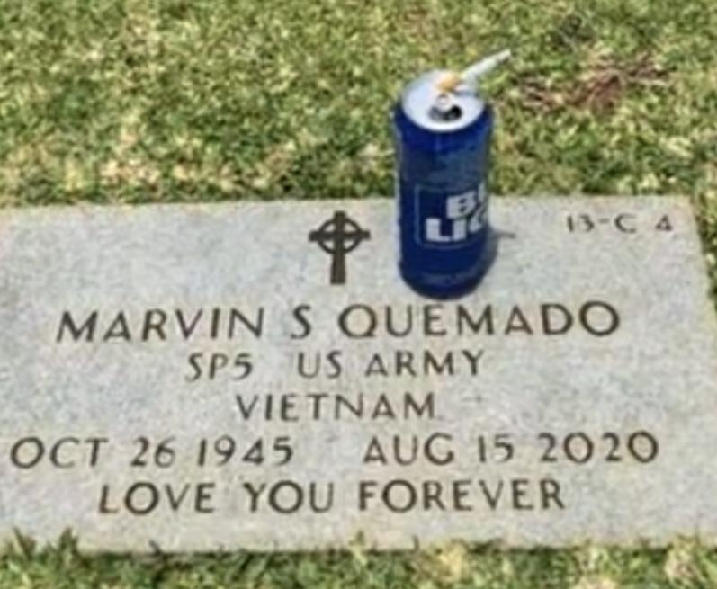 Family pays tribute at the grave of Marvin S Quemado with a drink placed on the marker.