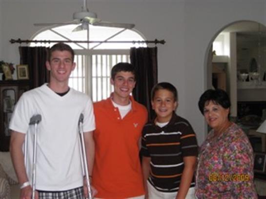 Friends and family gather in a sunny living room, sharing smiles and enjoying time together.